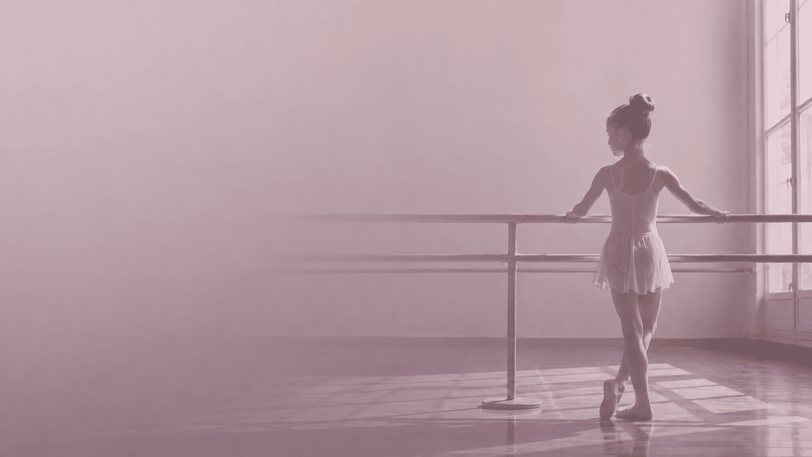 A young dancer smiling with her instructor